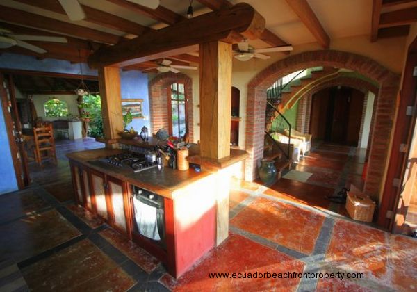 Large wood beams, brick archways, and stuccoed walls lend a rustic Mediterranean charm to this one-of-a-kind property