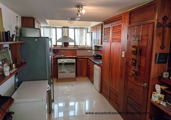 Kitchen is complete with large fridge, separate deep freezer, gas stove/oven, dishwasher, hood vent, and small appliances.