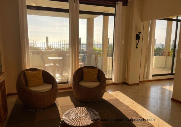 Living room looks out to the covered beachfront patio