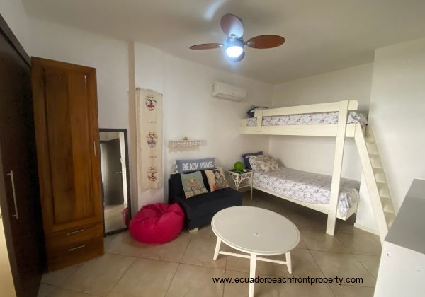 Spacious second bedroom with seating area and closet.