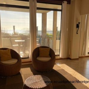 Living room looks out to the covered beachfront patio