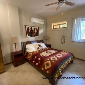 Master bedroom with queen bed, overhead fan and AC.