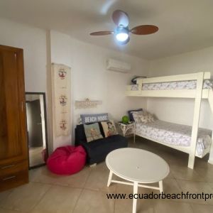 Spacious second bedroom with seating area and closet.