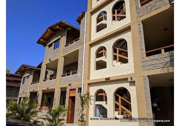 Mediterranean style face with split-faced block, wood details and a ceramic tile roof