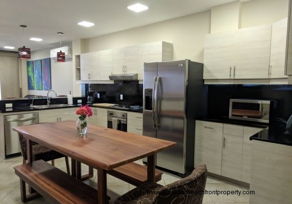 Kitchen with stainless appliances and custom wood dining table