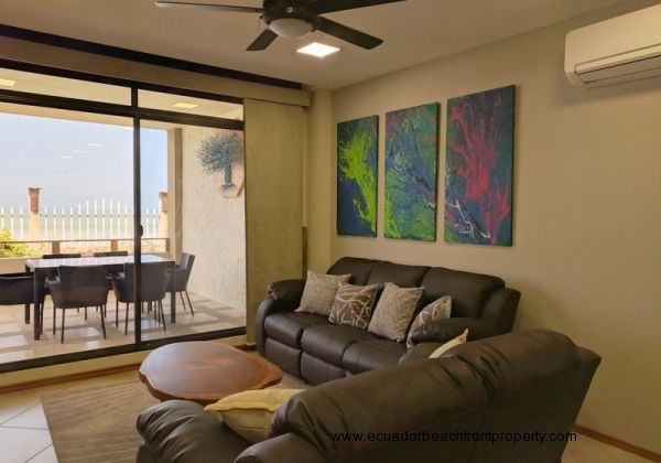 Oceanfront living room with sliding glass doors to the porch