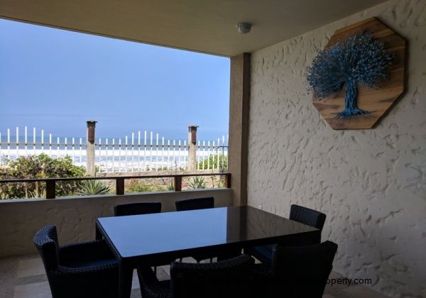 Oceanfront porch has a dining table for 6