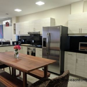 Kitchen with stainless appliances and custom wood dining table