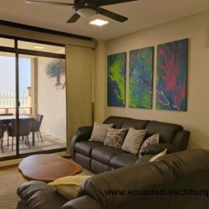 Oceanfront living room with sliding glass doors to the porch