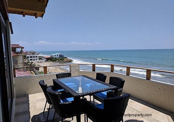 Oceanfront porch has a dining table for 6