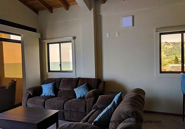 Oceanfront living room with sliding glass doors to the porch