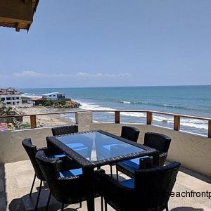 Oceanfront porch has a dining table for 6