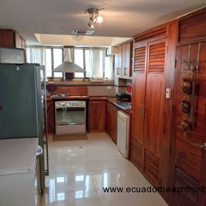 Kitchen is complete with large fridge, separate deep freezer, gas stove/oven, dishwasher, hood vent, and small appliances.