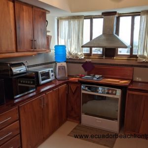 Well-equipped kitchen with wood cabinetry