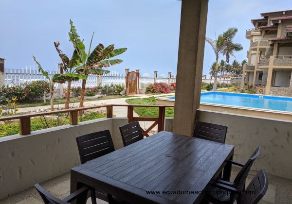 Balcony looking out at the pool and to the beach.