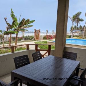 Balcony looking out at the pool and to the beach.