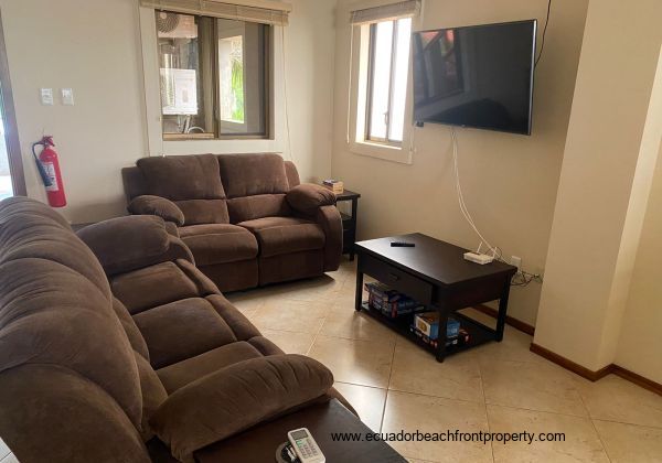 living room with two sets of reclining sofa