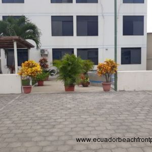 A view from the car park gate to the garden / patio / pool area at the back of the condo building.