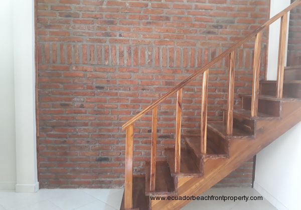 Staircase with a decorative feature brick wall up to the first floor.