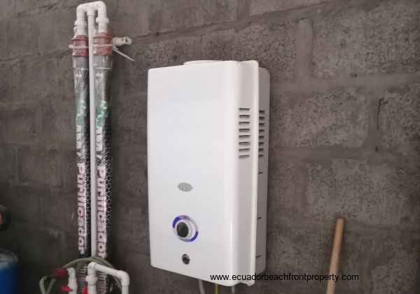 On demand water heater, Located in the outside storeroom.