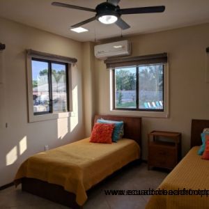 Second bedroom with twin beds and AC