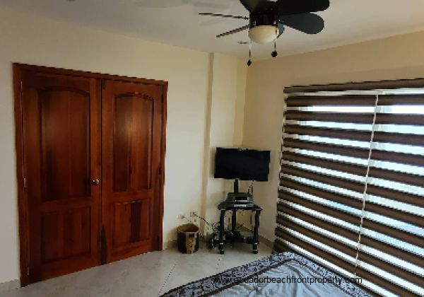 master bedroom has two closets, AC, overhead fan, TV, queen bed and access to the oceanfront balcony