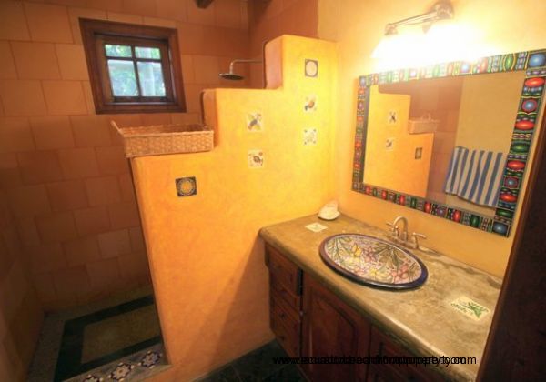 Downstairs shared bath with custom ceramic sink and walk-in shower