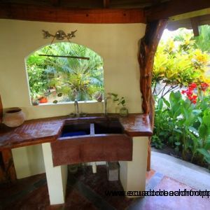 Outdoor kitchen overlooks the tropical gardens