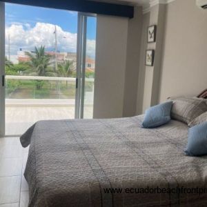 master bedroom has sliding doors to the ocean view balcony