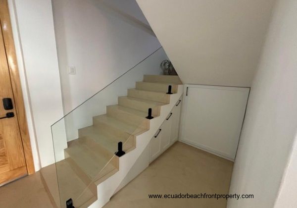 Stairway to 2nd level with storage cabinet