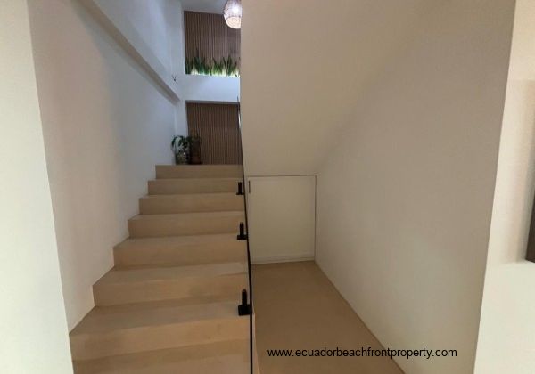 Stairway to 2nd level with storage cabinet