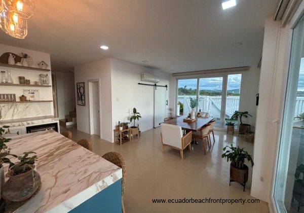 Kitchen opens to dining area with a table for 6
