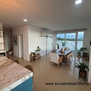 Kitchen opens to dining area with a table for 6
