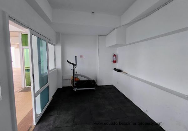 This is a shared space gym located on the bottom floor next to the pool.